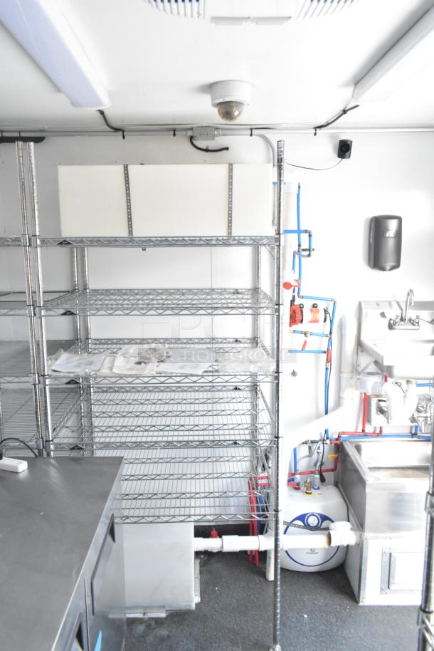 2021 Southern Dimensions mobile cold storage trailer interior with shelving, plumbing, and stainless steel workstation. Near-new condition.