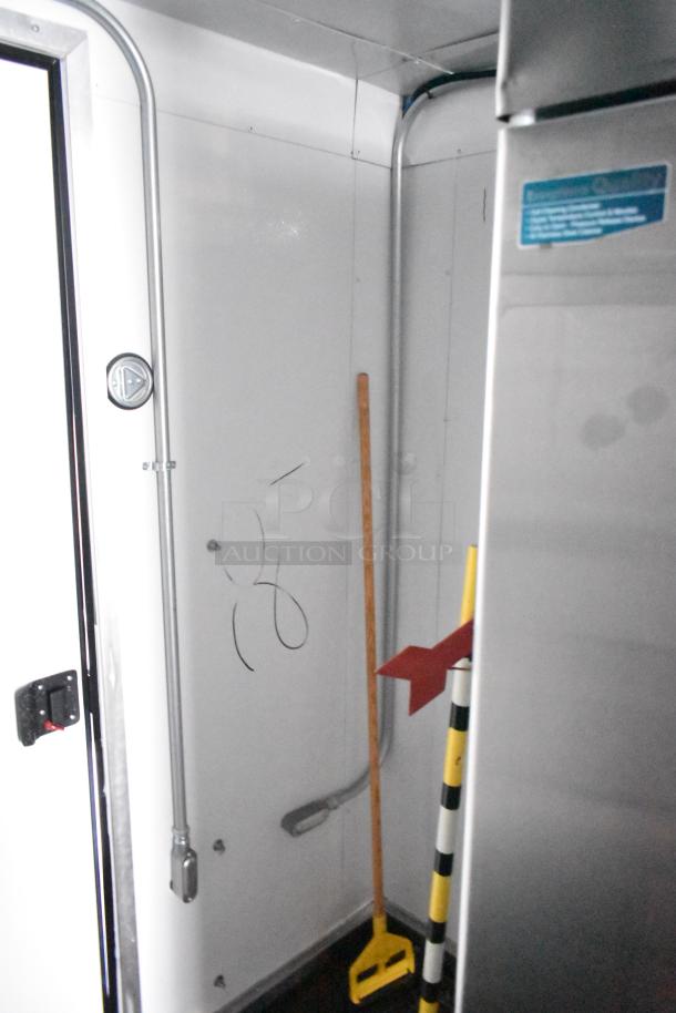 Interior view of a 2021 Southern Dimensions 8.5' x 24' mobile cold storage trailer in near-new condition, featuring plumbing and storage.