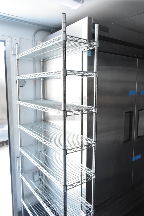 2021 Southern Dimensions mobile cold storage trailer interior with steel shelving near stainless steel coolers; near-new condition.