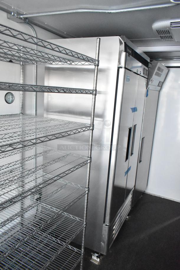 2021 Southern Dimensions 8.5' x 24' mobile cold storage trailer interior with wire shelving and stainless steel reach-in coolers.