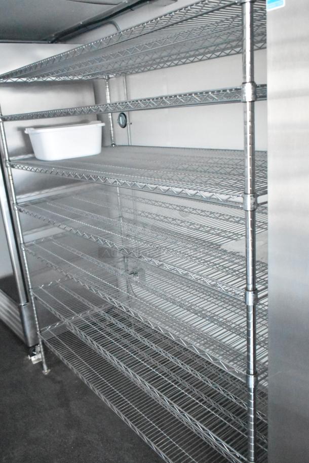 Interior of 2021 Southern Dimensions mobile cold storage trailer. Features durable metal shelving in near-new condition.