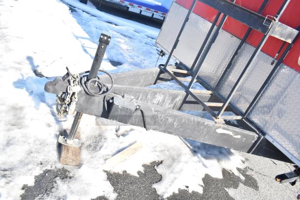 Rock Solid Cargo fast food trailer hitch on snowy ground, showing sturdy frame and chain, ideal for mobile kitchen setup.