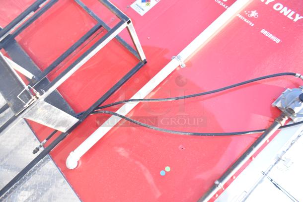 Red Rock Solid Cargo fast food trailer exterior with propane fittings and support rack. Ideal for mobile kitchen use.