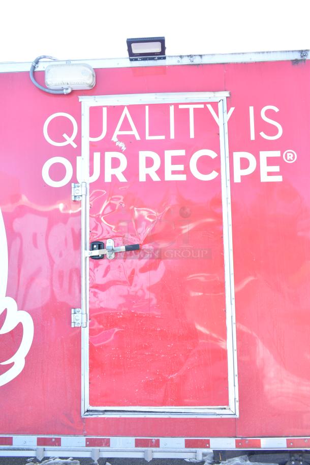 Rock Solid Cargo fast food trailer, red exterior with "Quality is Our Recipe" text. Features lockable service door.