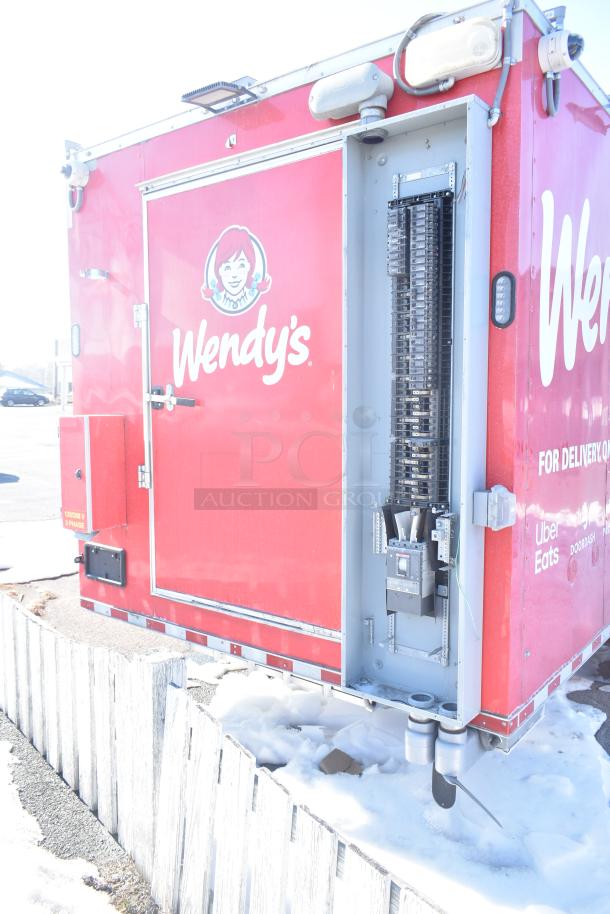 Red Rock Solid Cargo mobile kitchen trailer, Wendy's branding, equipped for fast-food service. Features utility panel and delivery app logos.