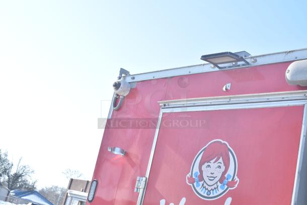 Red Rock Solid Cargo fast food trailer with Wendy's branding. Features secure locks and a mounted camera, ideal for turnkey operation.
