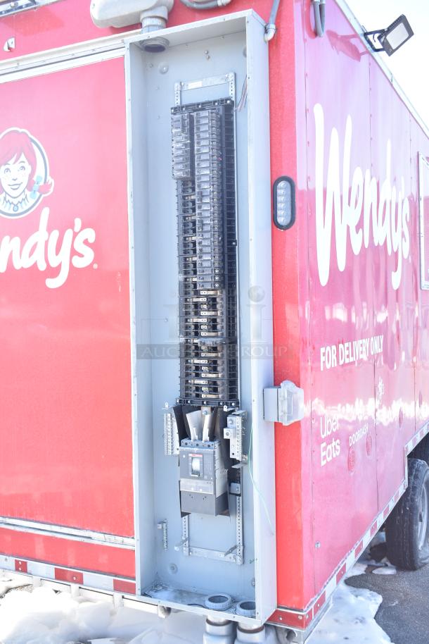Red Rock Solid Cargo trailer outfitted as Wendy's fast-food kitchen. Visible electrical panel, Wendy’s logo, and delivery branding.