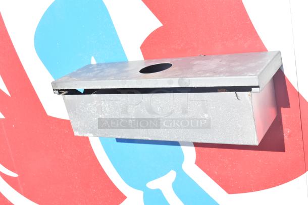 Metallic component on the exterior of a mobile kitchen trailer, with a red and blue background.