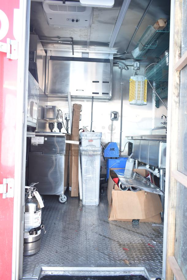 Rock Solid Cargo fast food trailer interior, fully equipped with commercial kitchen appliances and stainless steel fixtures.