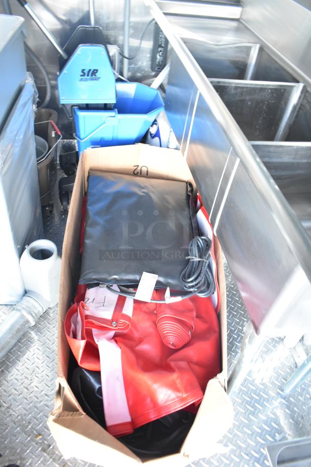 Rock Solid Cargo fast-food trailer interior with SIR mop bucket, sinks, and cleaning supplies for turnkey operation.