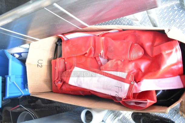 Box containing red equipment or materials labeled "U2" inside the Rock Solid Cargo fast food trailer. Items appear clean and organized.