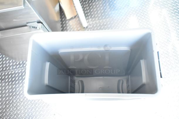 Rock Solid Cargo trailer interior with a plastic container on a metal floor. No visible equipment.