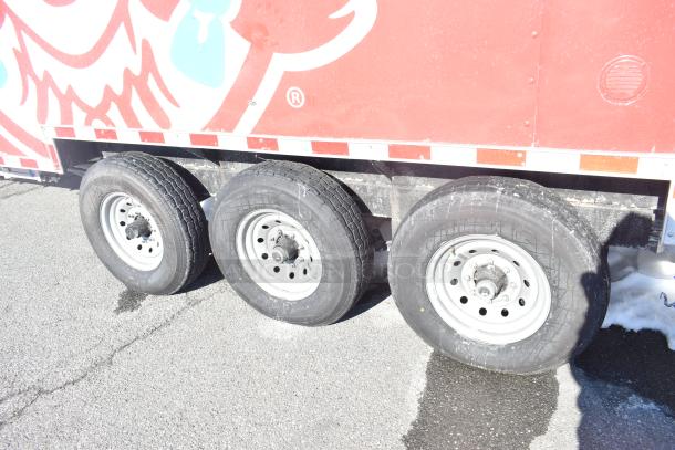 Rock Solid Cargo fast food trailer with visible rear wheels. Red Wendy's-themed exterior. Suitable for mobile kitchen use.