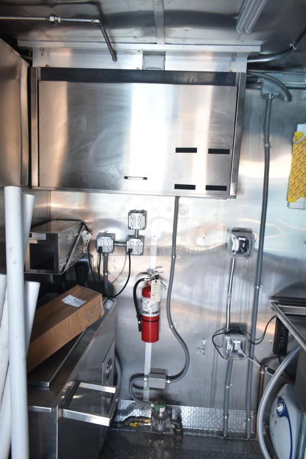 Rock Solid Cargo fast food trailer interior with commercial-grade appliances, fire extinguisher, and electrical outlets.