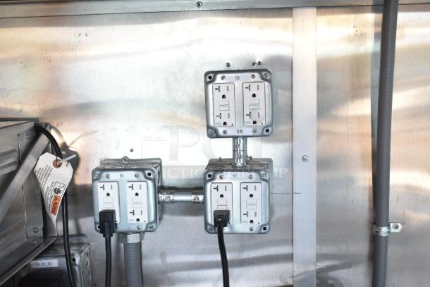 Mobile kitchen outlet panel with labeled sockets, showcasing electrical setup in a Rock Solid Cargo fast-food trailer.