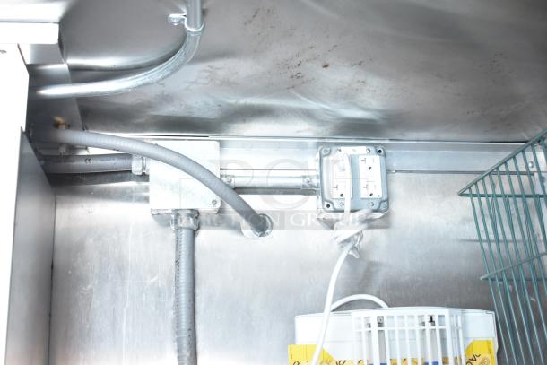 Electrical panel and wiring inside Rock Solid Cargo fast-food trailer, featuring outlets and conduit in clean condition.