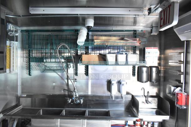 Rock Solid Cargo fast food trailer interior with triple sink, shelves, and dispensers; ideal for high-volume service.