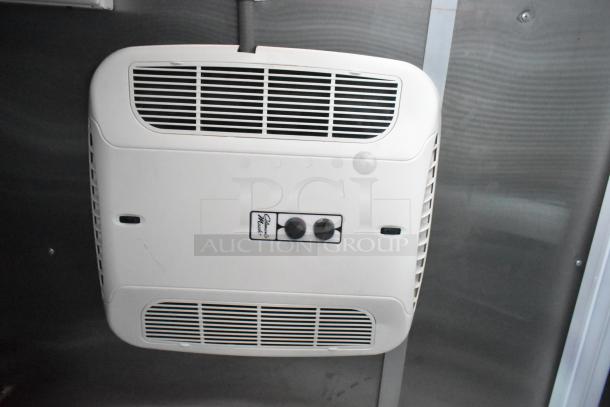 "Ceiling-mounted climate control unit with control knobs in Rock Solid Cargo fast-food trailer. Features streamlined vents."