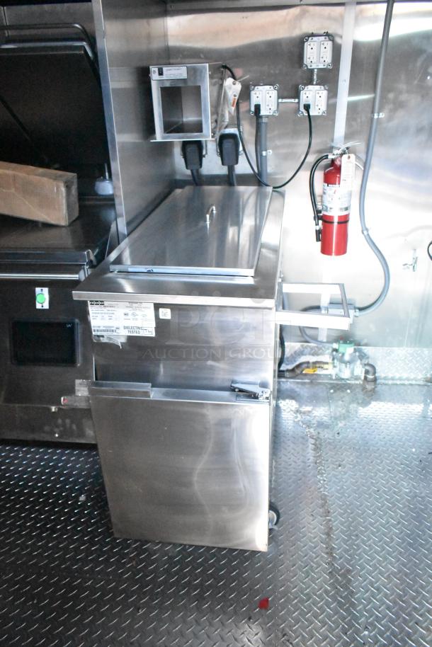 Rock Solid Cargo fast-food trailer interior, featuring stainless steel appliances, SaniServ ice cream machine, and Henny Penny gas fryer.