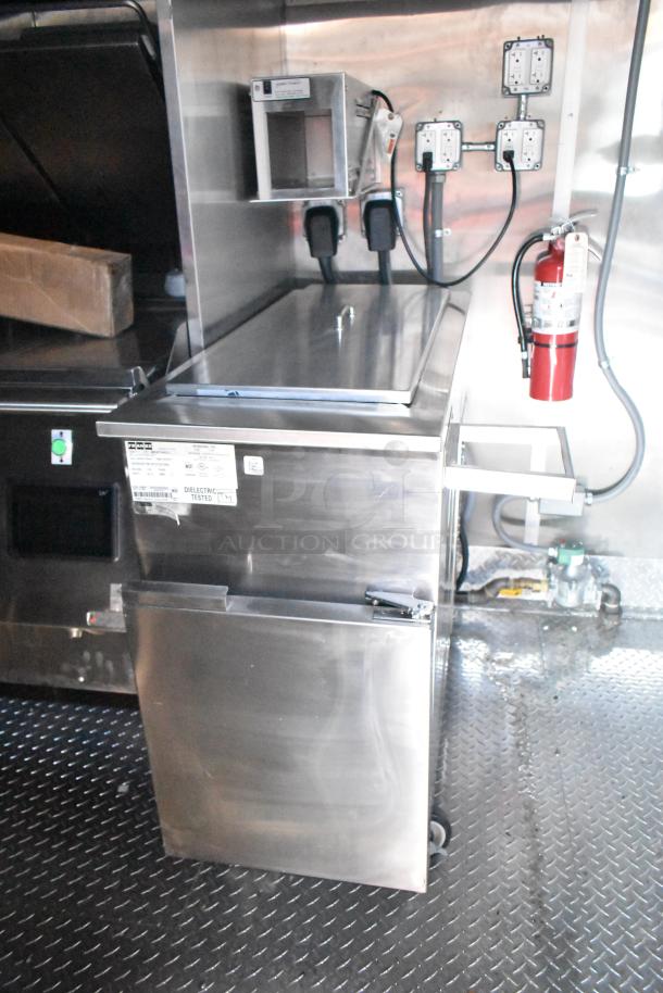 Rock Solid Cargo fast food trailer interior with stainless steel equipment, grease hood, and electrical panel. Mint condition.