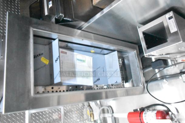 Rock Solid Cargo fast food trailer interior showing commercial-grade hood, fixture setups, and fire extinguisher.