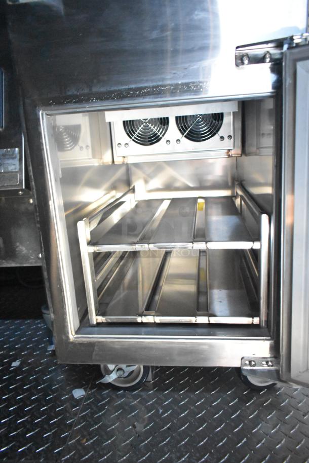 Rock Solid Cargo mobile kitchen interior showing stainless steel shelving and cooling fans. Ideal for high-volume service.