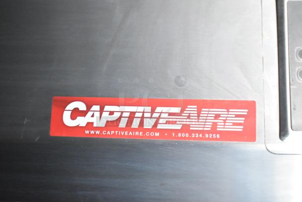 Close-up of CaptiveAire label on stainless steel featuring branding, website, and contact number for the grease hood system.