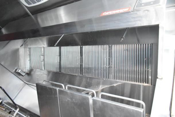 CaptiveAire grease hood in a Rock Solid Cargo fast-food trailer, stainless steel, new condition, ideal for high-volume use.