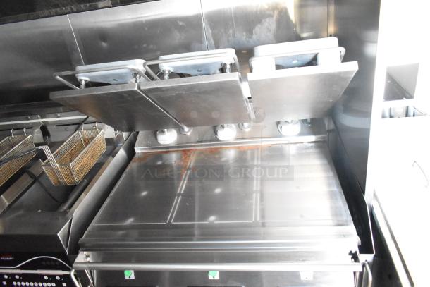 Rock Solid Cargo fast food trailer kitchen with grill, fryers, and commercial-grade stainless steel equipment. Ideal for high-volume.