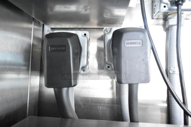 Electrical connectors inside Rock Solid Cargo fast-food trailer, showing Hubbell and Amphenol plugs used in commercial systems.