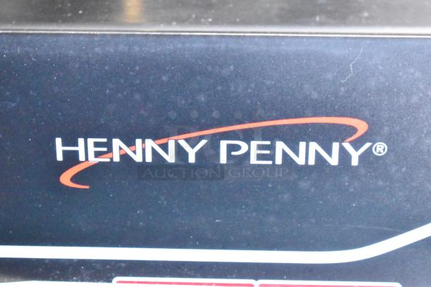 Henny Penny logo on restaurant-grade equipment in mobile fast food trailer, professionally equipped for high-volume service.