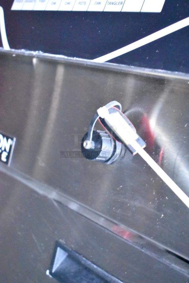Close-up of a control knob and label inside a Rock Solid Cargo fast-food trailer kitchen.