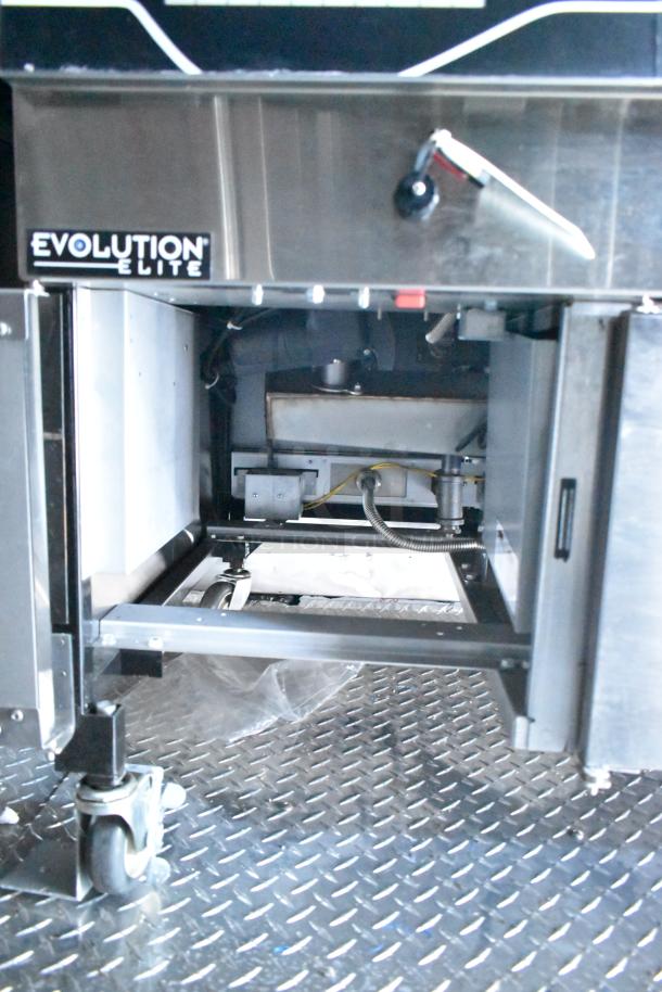 Rock Solid Cargo mobile kitchen interior with Evolution Elite system and wheels on diamond plate floor. Optimal for fast-food operations.