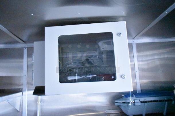 Rock Solid Cargo fast-food trailer interior, featuring metal cabinetry with visible wiring and sleek stainless steel finish.