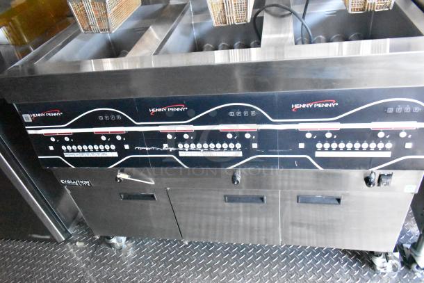 Henny Penny gas fryer in a Rock Solid Cargo fast-food trailer, featuring multiple controls and baskets, ideal for high-volume service.