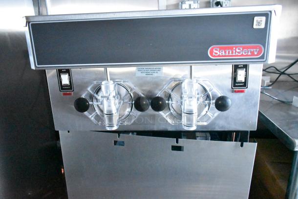 SaniServ ice cream machine in metal casing with dual dispensers, part of a fully equipped Rock Solid Cargo mobile kitchen.