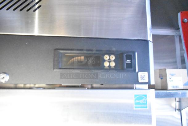 Stainless steel interior with control panel of Rock Solid Cargo fast food trailer. QR code and logo sticker visible.