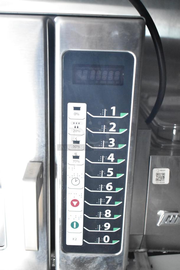 Control panel of a commercial-grade kitchen appliance with numbered settings 1-9 and functions for moisture and heat.