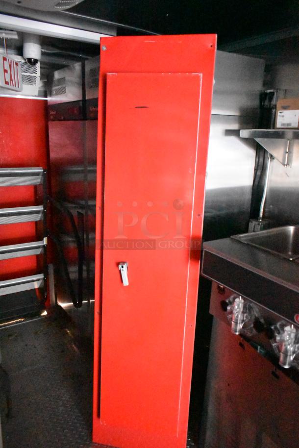 Red interior view of Rock Solid Cargo fast food trailer with stainless steel sink and fixtures. Ideal for mobile kitchen setup.