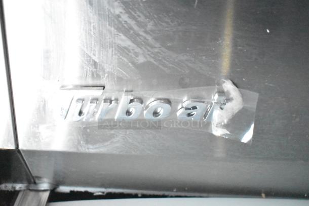 Metal surface with "turbo air" logo on a commercial kitchen appliance in a Rock Solid Cargo fast-food trailer.