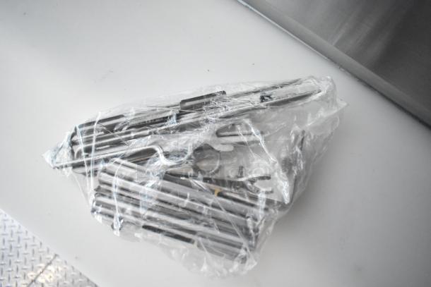 Plastic-wrapped metal components for Rock Solid Cargo mobile kitchen, likely part of the installation or operational setup.