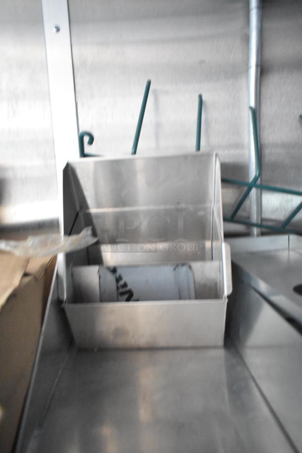 Interior of a 2022 Rock Solid Cargo fast-food trailer, showing a stainless steel fixture. Ideal for high-volume service.
