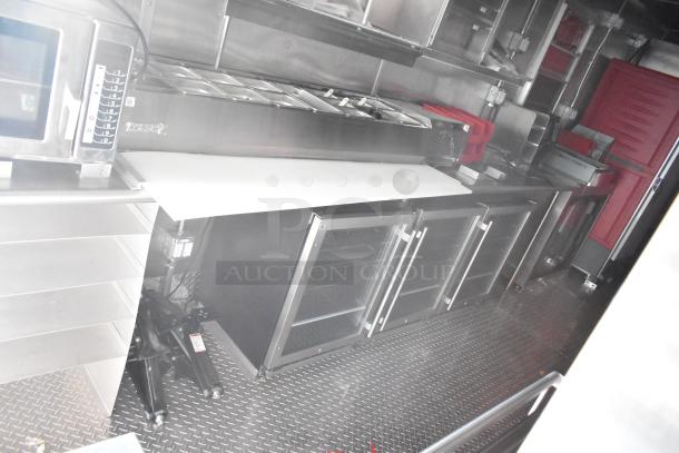 Rock Solid Cargo mobile kitchen trailer, equipped with commercial appliances like a CaptiveAire hood and refrigeration units.