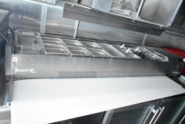 Rock Solid Cargo mobile kitchen with stainless steel prep station, refrigeration, food pans, and commercial-grade equipment.