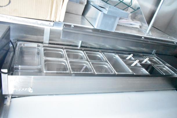 Rock Solid Cargo fast food trailer prep area with stainless steel food pans and storage, ideal for high-volume service.