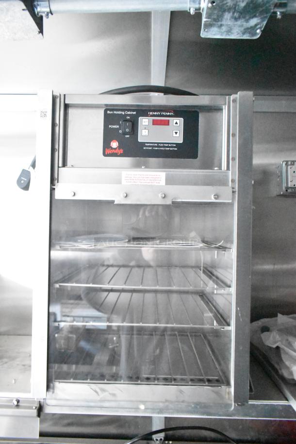Henny Penny bun holding cabinet in a Rock Solid Cargo Wendy's fast food trailer, featuring temperature control and logo branding.