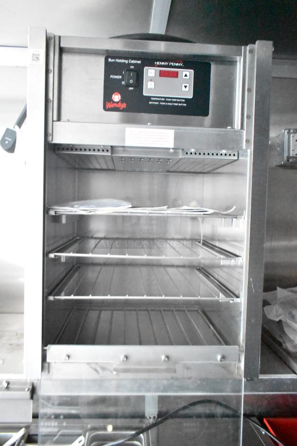 Stainless steel Henny Penny bun holding cabinet in Wendy's mobile kitchen trailer, featuring digital controls.
