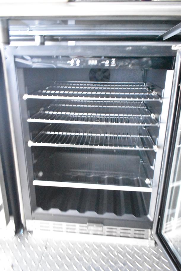 Rock Solid Cargo fast-food trailer refrigeration unit, featuring multiple wire shelves, ideal for mobile kitchen setup.