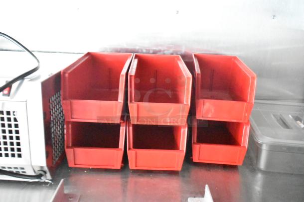 Red plastic storage bins inside a Rock Solid Cargo fast food trailer, featuring a CaptiveAire grease hood.