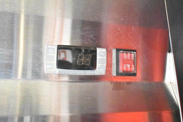 Digital temperature display for Dixell refrigerator in a Rock Solid Cargo fast food trailer, showing settings.